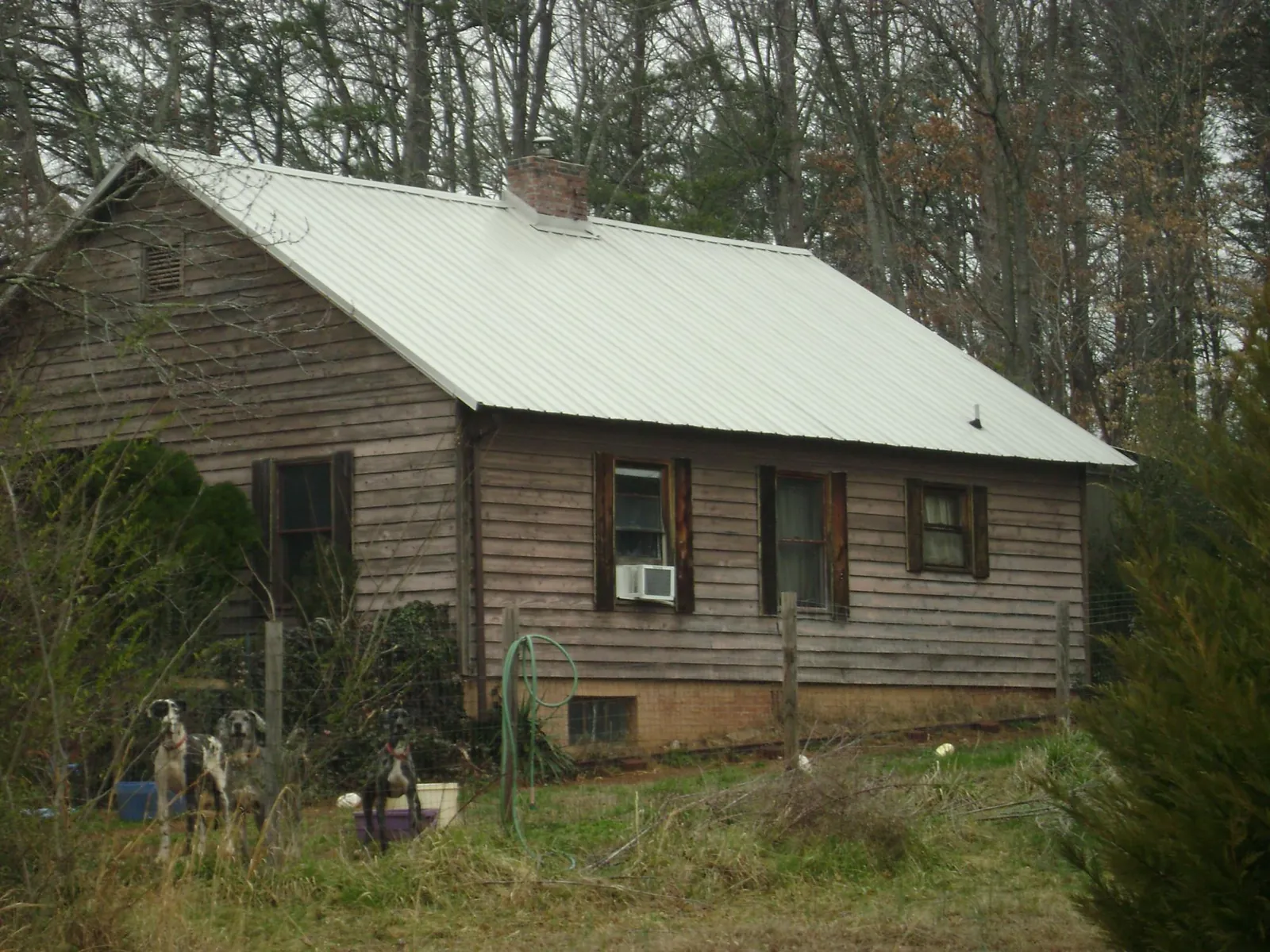 White metal roof on an old wood sided farmhouse, from a Metal Roof Installation job in Bogota